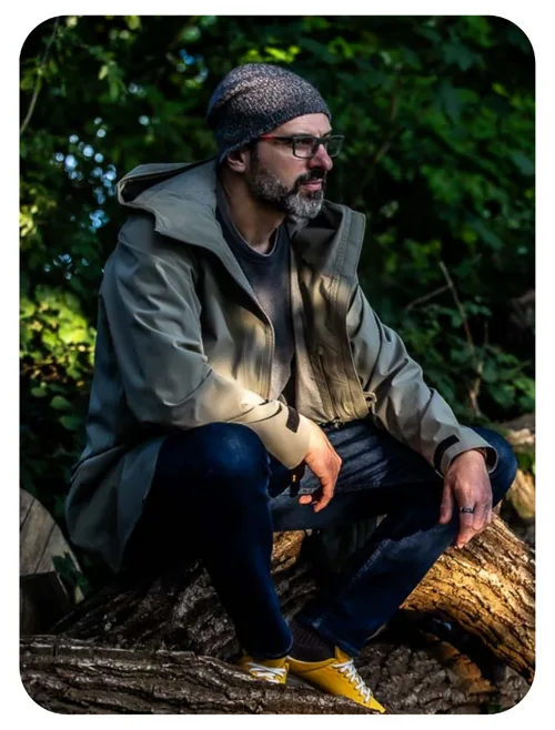 Nathan Simmonds, founder of Spirit Medicine, sitting contemplatively in nature